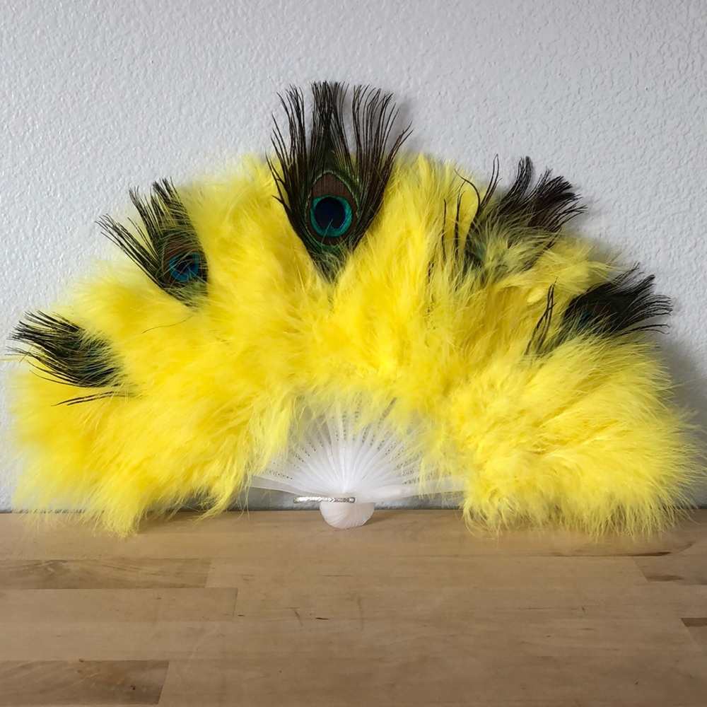 Yellow handheld feather fan with peacock feathers